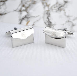Envelope cufflinks with lucky clover engraved on the front of both cufflinks, shown in close up shot.